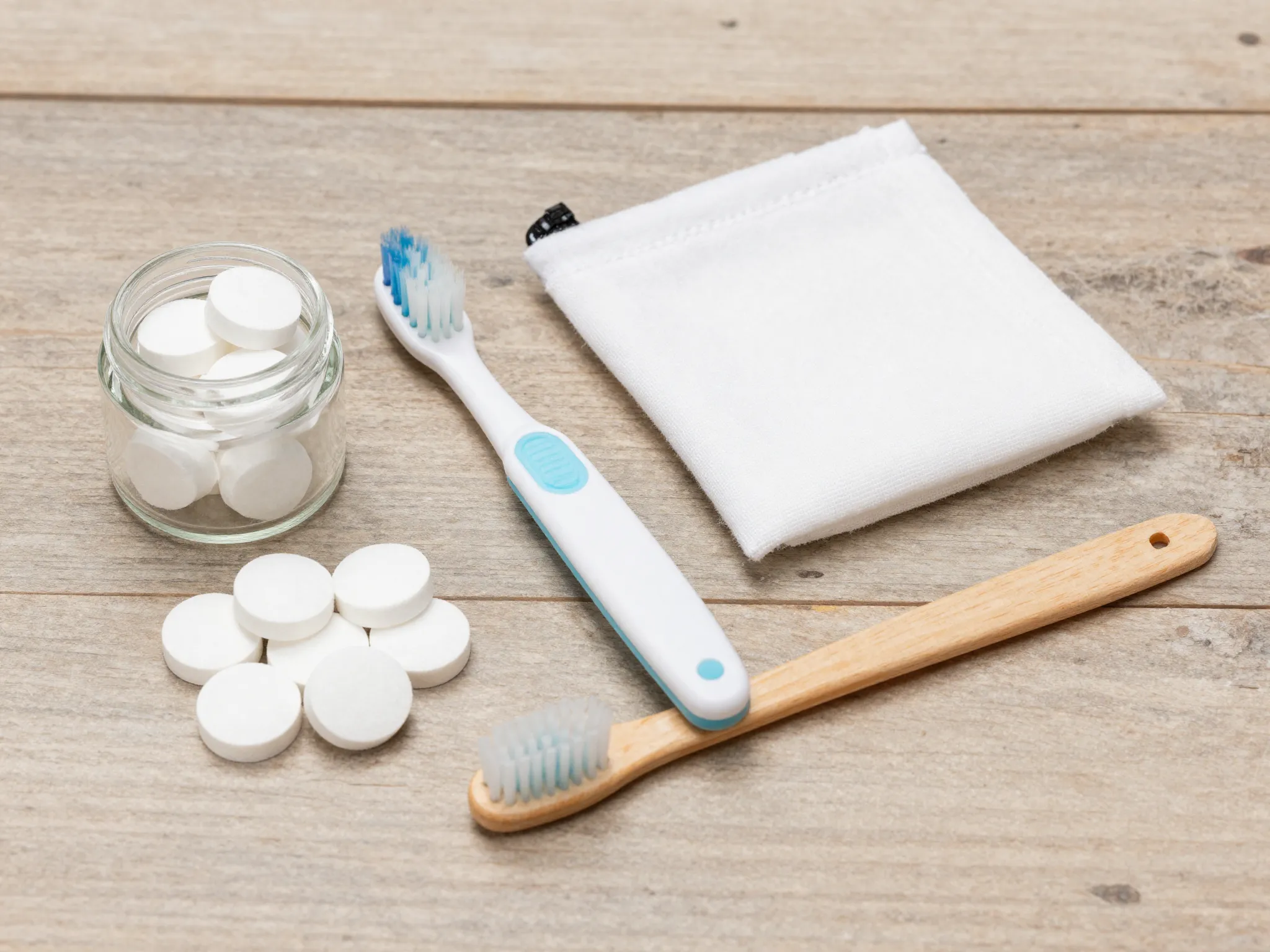 Folding toothbrush with toothpaste tablets and baking soda alternative
