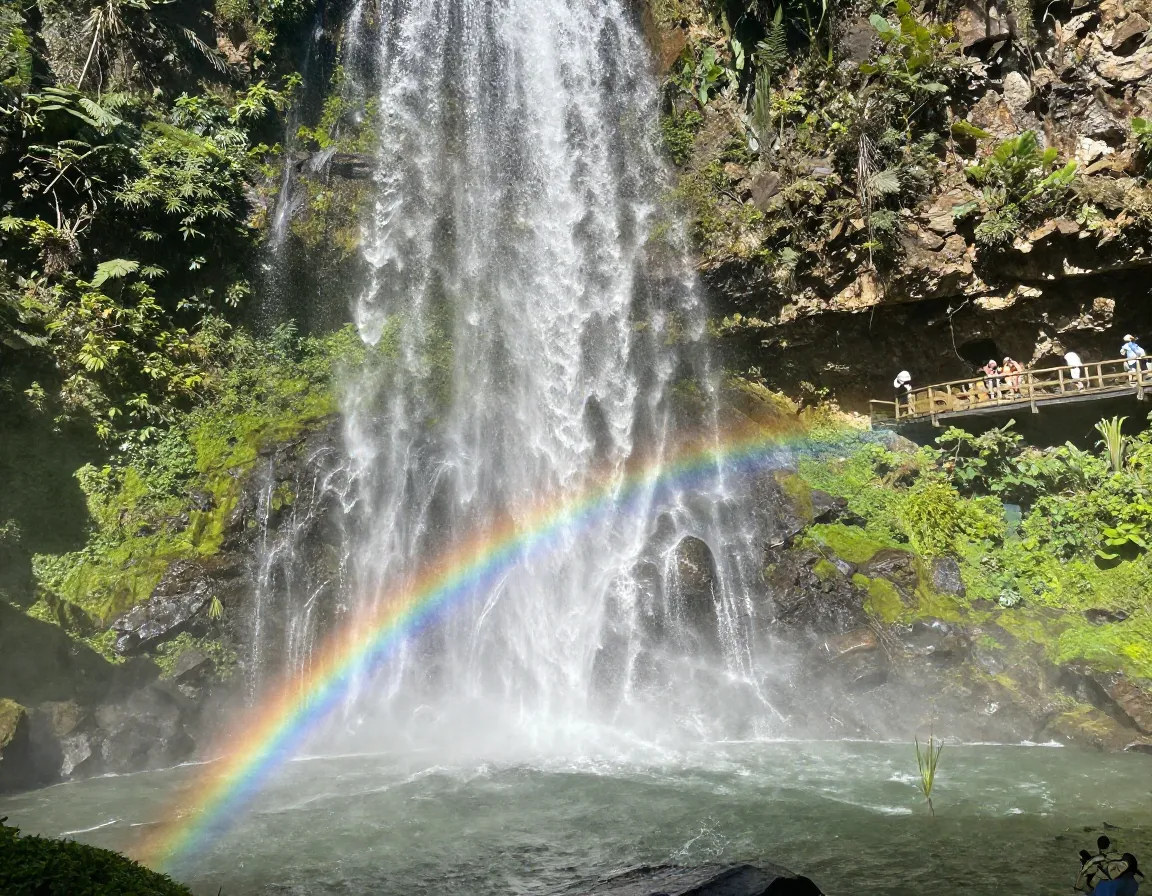 Sunny afternoon at eighty foot waterfall creating rainbow mist