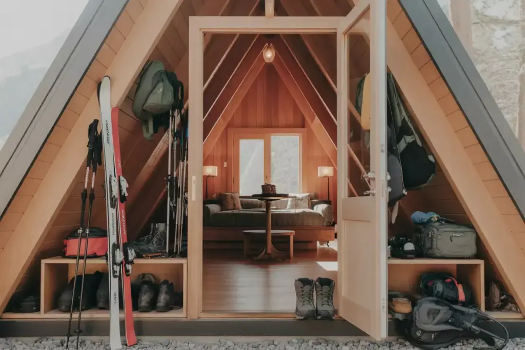 Architectural Efficiency A Frame Cabin Interior With Organized Adventure Gear And Loft Space