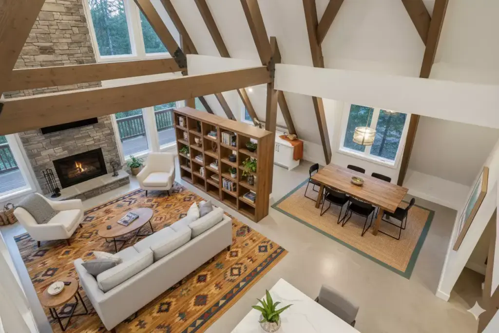 Open Plan A Frame Interior With Rugs And Furniture Defining Living And Dining Zones