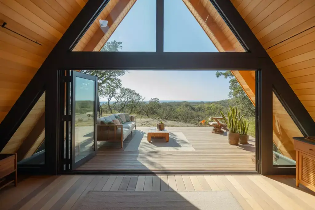 Seamless Indoor Outdoor A Frame Living Space With Open Sliding Doors And Deck