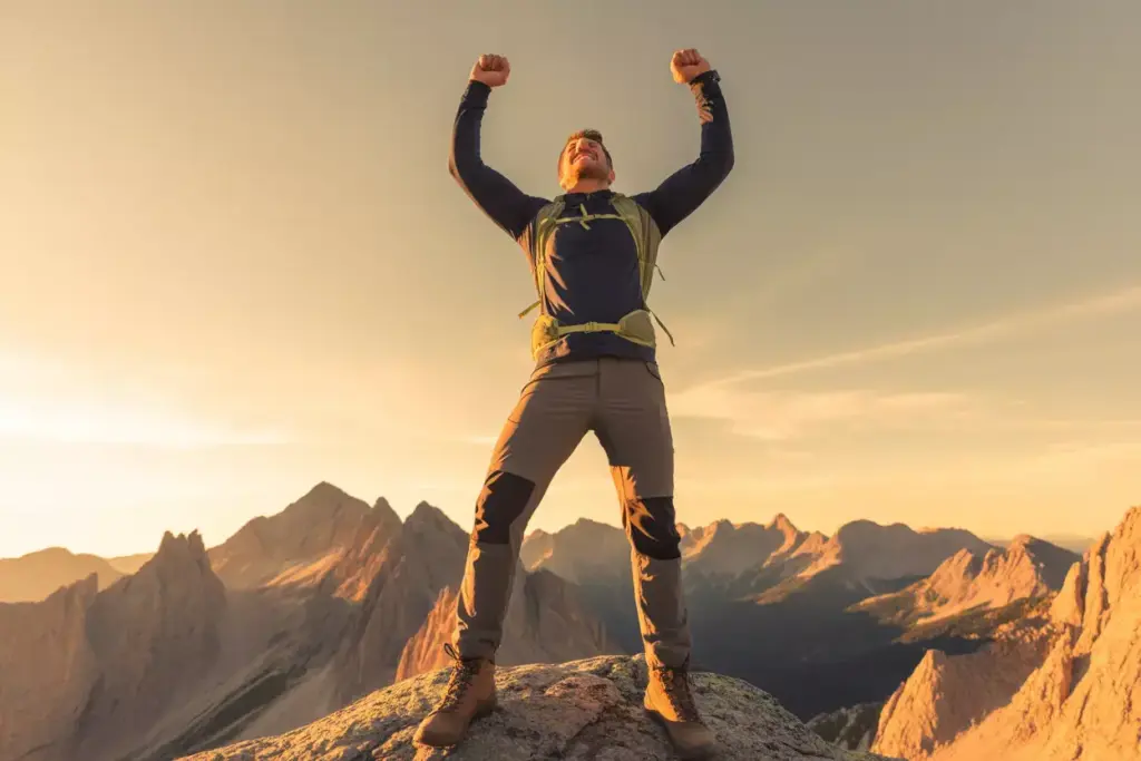 11 The Summit Conqueror Pose Man Standing Triumphantly On Mountain Peak At Golden Hour