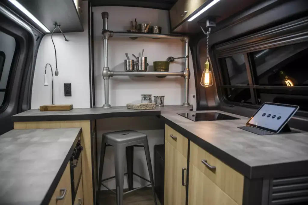 Industrial Modern Van Kitchen With Concrete Countertops And Metal Shelving