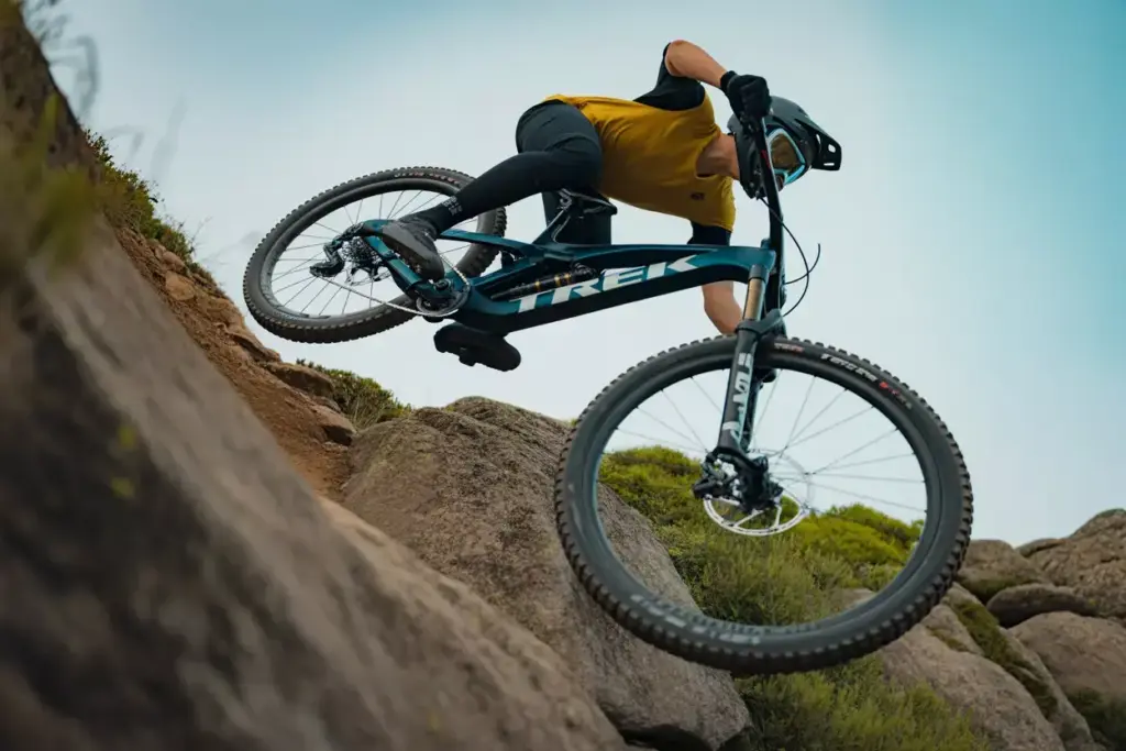 Trek Fuel EX 130mm Rear Travel Mountain Bike Jumping Over Rocky Trail Section Action Shot