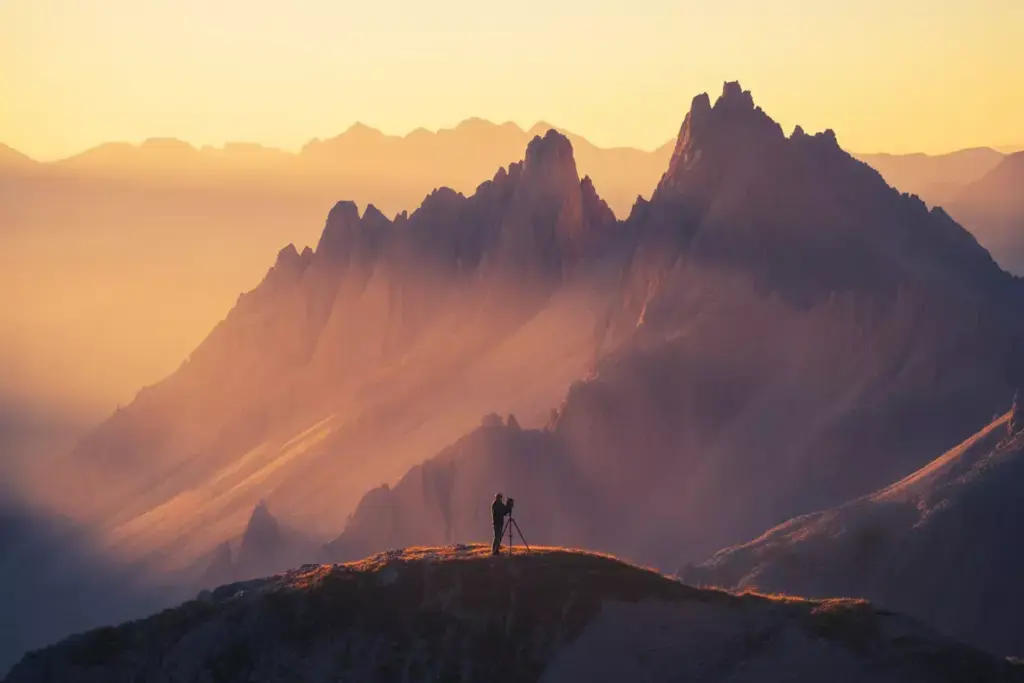 33 Mountain Peaks Bathed In Warm Golden Hour Light With Long Dramatic Shadows