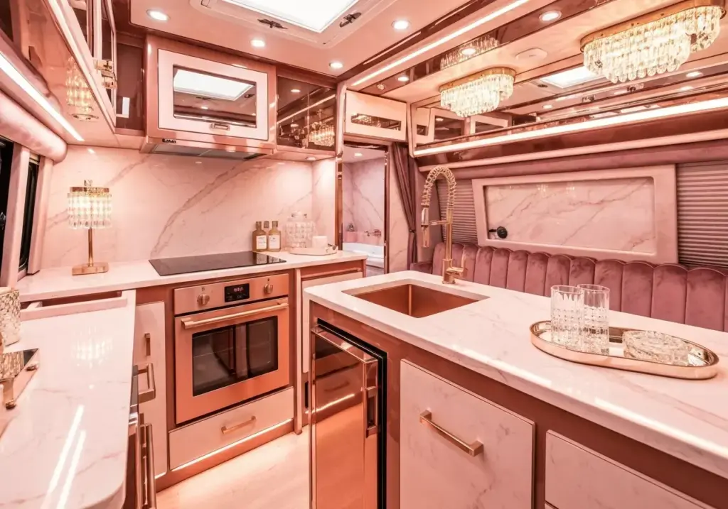 A Luxury Van Interior With Pink Marble Countertops Rose Gold Fixtures And Velvet Upholstery