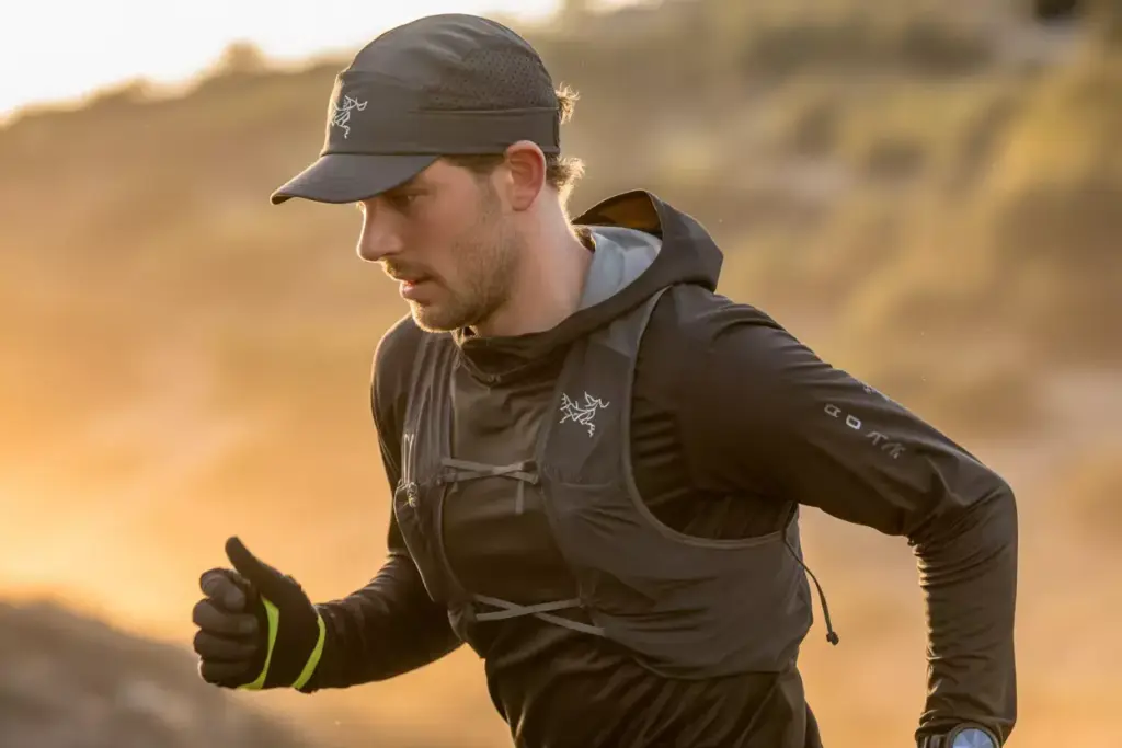 A Runner Wearing The Arc Teryx Norvan Trucker Hat In A Summer Trail Ensemble