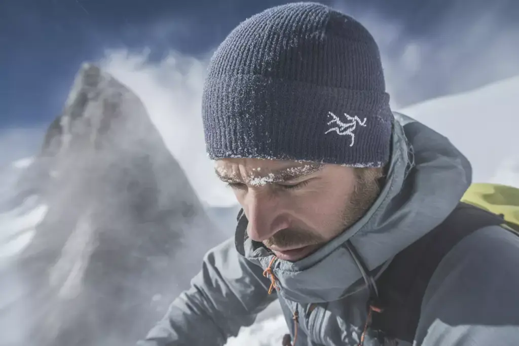 Arc Teryx Rho Ar Beanie Worn In Sub Zero Alpine Climbing Environment With Frost And Snow