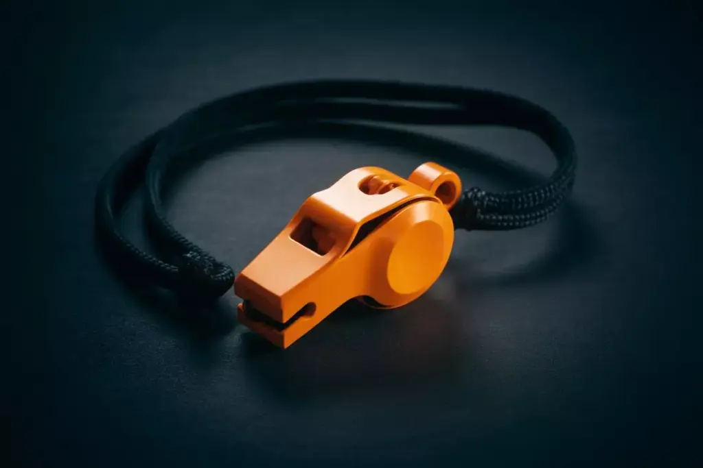 Bright Orange Pealess Emergency Whistle On A Lanyard For Distress Signaling
